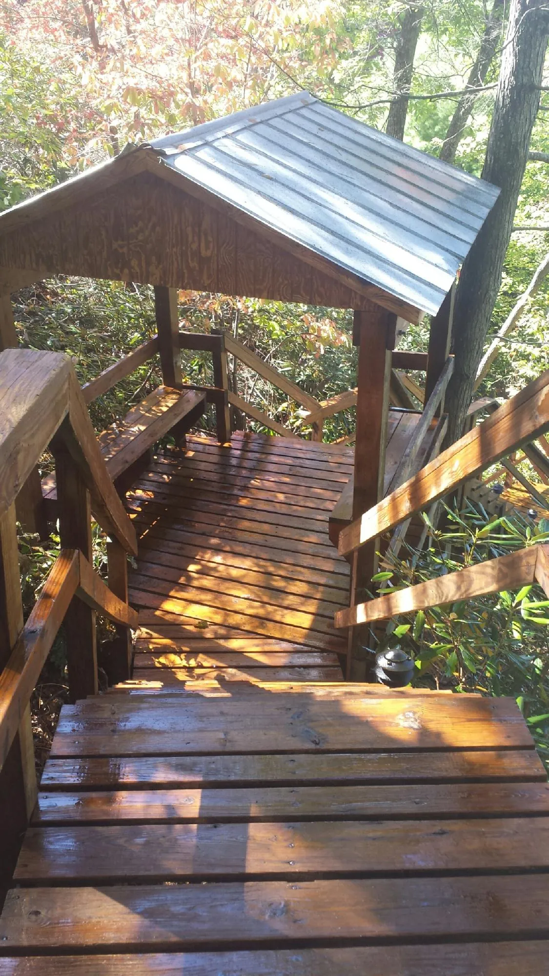 Freshly stained wood walkway and covered shelter with a metal roof in Atlanta